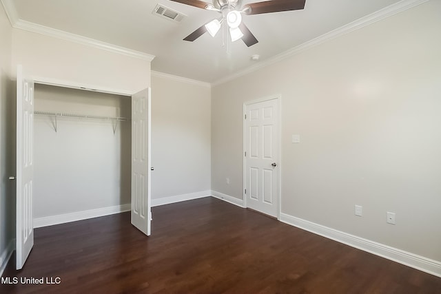 unfurnished bedroom featuring visible vents, baseboards, a closet, dark wood finished floors, and crown molding