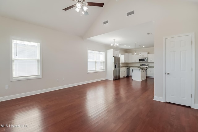 unfurnished living room featuring baseboards, visible vents, dark wood finished floors, and ceiling fan with notable chandelier