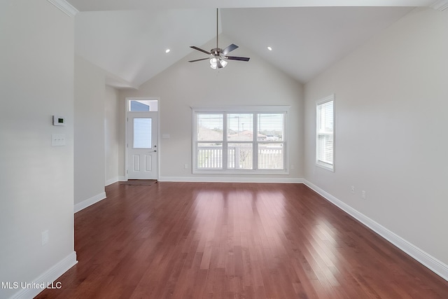 unfurnished living room with high vaulted ceiling, dark wood-style flooring, and baseboards