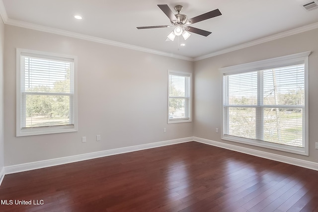 empty room with dark wood-style floors, crown molding, visible vents, and baseboards