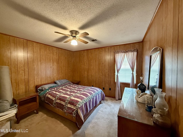126 Lyon Dr, Grenada, MS 38901 - carpeted bedroom with ceiling fan, a textured ceiling, and wooden walls