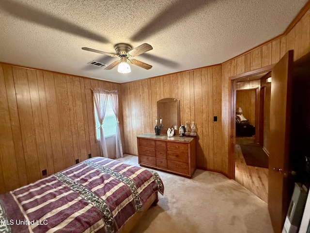 126 Lyon Dr, Grenada, MS 38901 - bedroom with light carpet, ceiling fan, wooden walls, and a textured ceiling