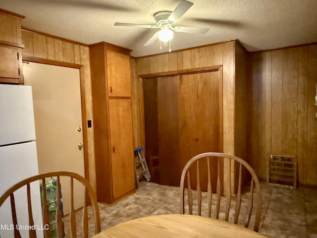 126 Lyon Dr, Grenada, MS 38901 - dining area featuring ceiling fan, a textured ceiling, and wood walls