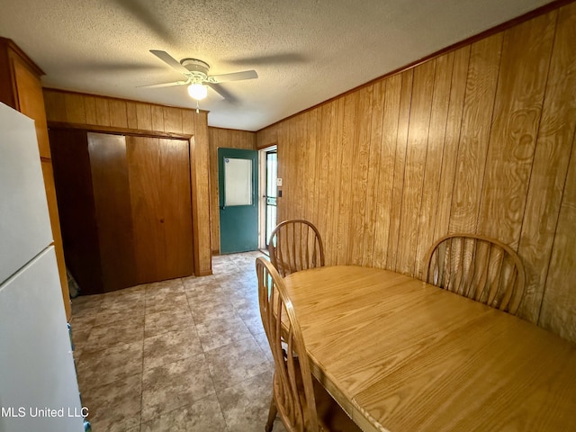126 Lyon Dr, Grenada, MS 38901 - dining space featuring ceiling fan, a textured ceiling, and wood walls