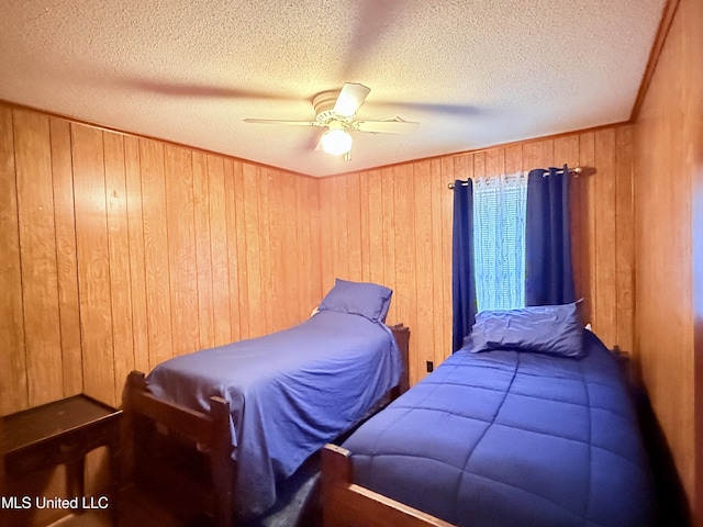 126 Lyon Dr, Grenada, MS 38901 - bedroom with crown molding, ceiling fan, wooden walls, and a textured ceiling