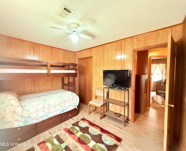 126 Lyon Dr, Grenada, MS 38901 - bedroom featuring light hardwood / wood-style flooring and wooden walls