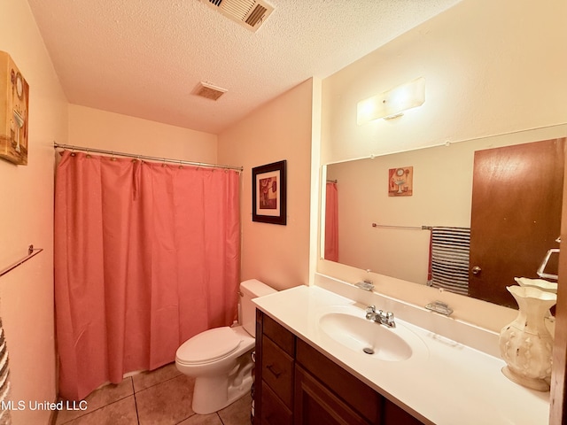 126 Lyon Dr, Grenada, MS 38901 - bathroom featuring tile patterned floors, toilet, vanity, and a textured ceiling