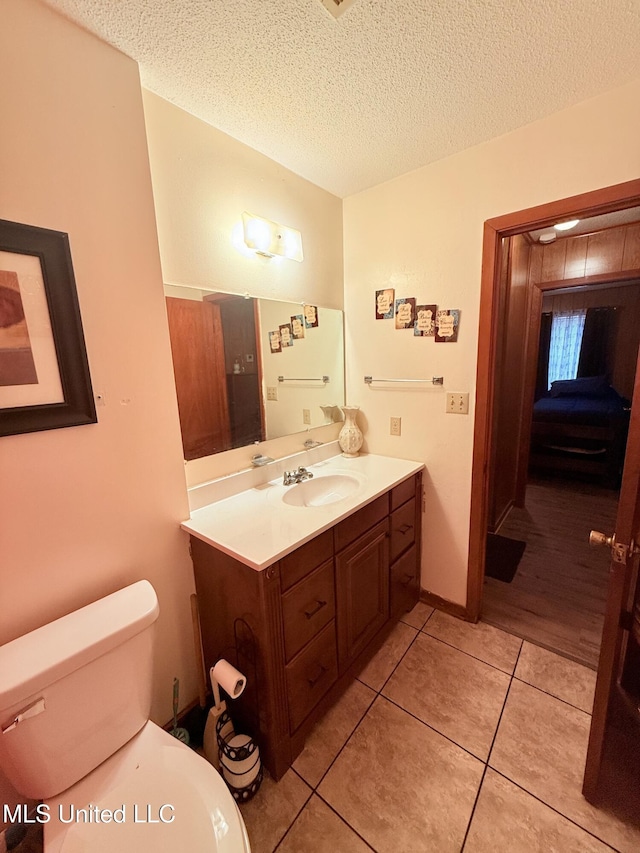 126 Lyon Dr, Grenada, MS 38901 - bathroom with vanity, tile patterned flooring, toilet, and a textured ceiling
