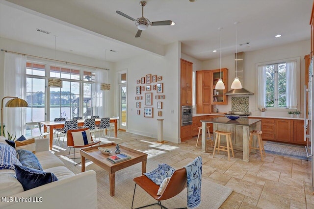 living room featuring a water view and ceiling fan