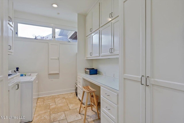 clothes washing area with cabinets and independent washer and dryer