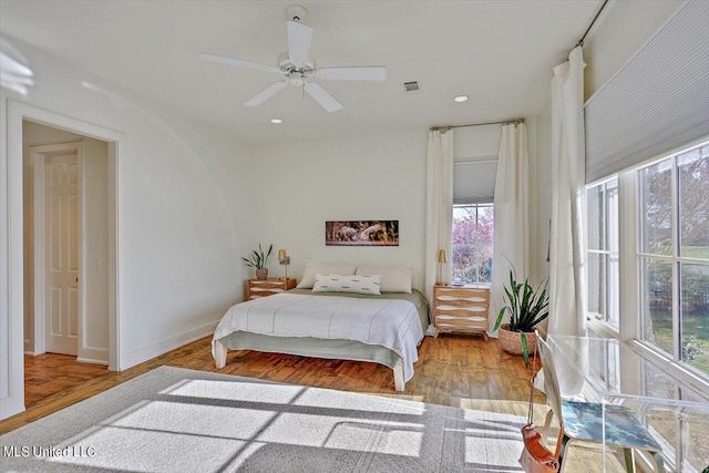 bedroom with ceiling fan and hardwood / wood-style floors