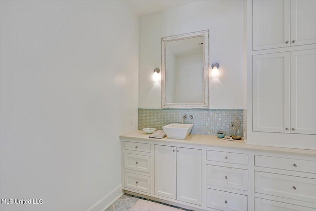 bathroom featuring vanity and backsplash