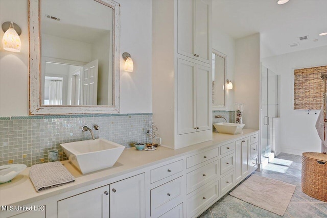 bathroom featuring vanity, decorative backsplash, and an enclosed shower