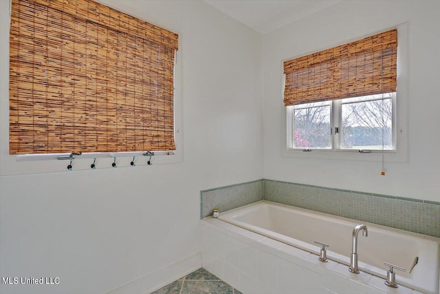 bathroom featuring tile patterned floors and a relaxing tiled tub