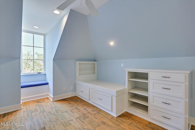 additional living space with ceiling fan, light wood-type flooring, and vaulted ceiling