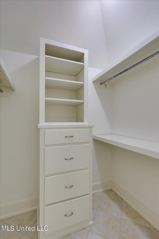 spacious closet with light tile patterned flooring