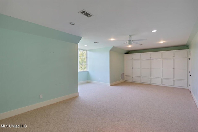 carpeted spare room featuring ceiling fan