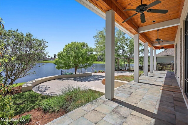 view of patio / terrace featuring a water view and ceiling fan