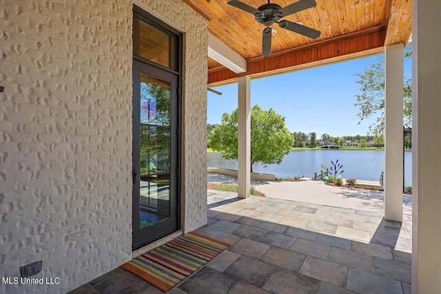 entryway with a water view, ceiling fan, and wooden ceiling