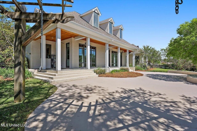 rear view of house featuring covered porch