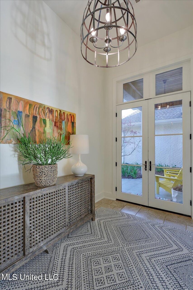 entryway featuring french doors and a chandelier