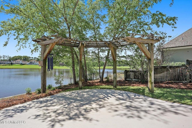 view of patio / terrace with a water view and a pergola