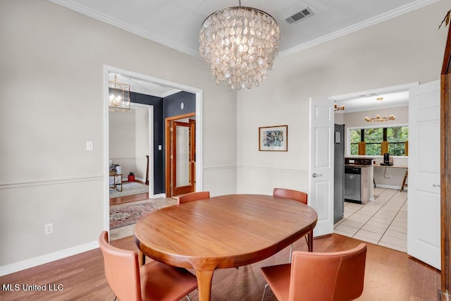 807 Woodglen Dr, Ocean Springs, MS 39564 - dining area featuring a chandelier, ornamental molding, light wood-style floors, and baseboards