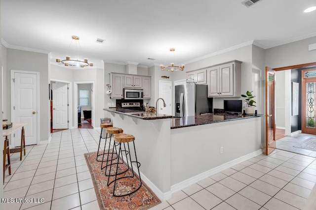 807 Woodglen Dr, Ocean Springs, MS 39564 - kitchen with a chandelier, stainless steel appliances, light tile patterned floors, gray cabinets, and crown molding