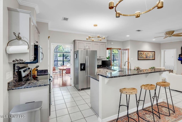 807 Woodglen Dr, Ocean Springs, MS 39564 - kitchen with stainless steel appliances, healthy amount of natural light, a chandelier, a kitchen breakfast bar, and ornamental molding