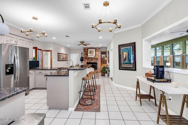 807 Woodglen Dr, Ocean Springs, MS 39564 - kitchen with stainless steel fridge with ice dispenser, a ceiling fan, a chandelier, crown molding, and recessed lighting