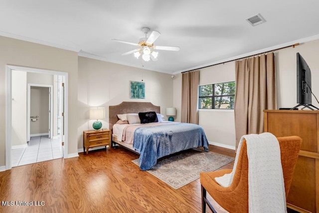 807 Woodglen Dr, Ocean Springs, MS 39564 - bedroom featuring ornamental molding, light wood-style floors, a ceiling fan, baseboards, and ensuite bathroom