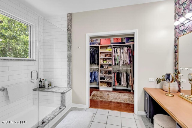 807 Woodglen Dr, Ocean Springs, MS 39564 - full bath featuring a shower stall, tile patterned flooring, a spacious closet, and baseboards