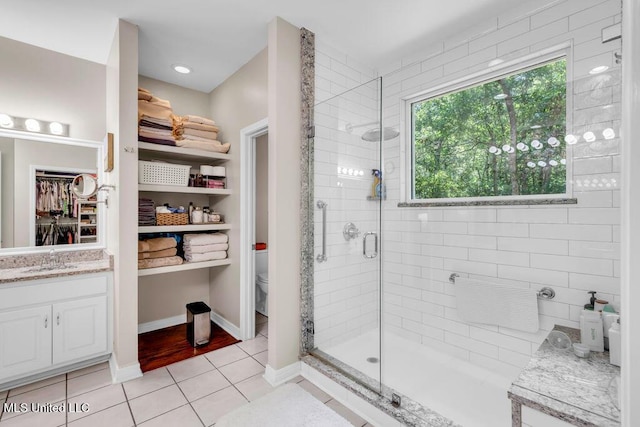 807 Woodglen Dr, Ocean Springs, MS 39564 - bathroom with a stall shower, a walk in closet, toilet, tile patterned flooring, and vanity