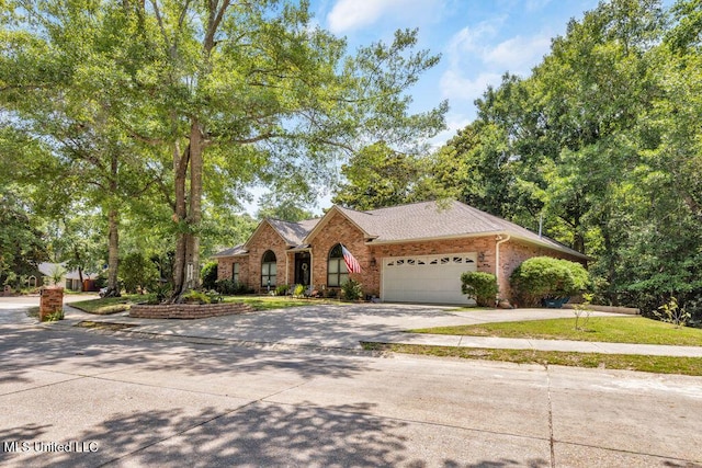 807 Woodglen Dr, Ocean Springs, MS 39564 - view of front facade with brick siding, driveway, a garage, and a shingled roof