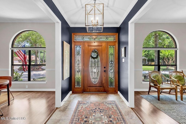 807 Woodglen Dr, Ocean Springs, MS 39564 - foyer entrance featuring a chandelier, baseboards, light wood-type flooring, and ornamental molding