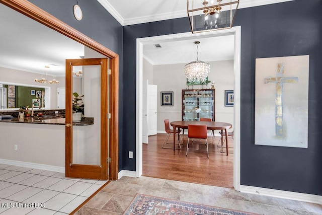 807 Woodglen Dr, Ocean Springs, MS 39564 - entryway featuring a chandelier, crown molding, and baseboards