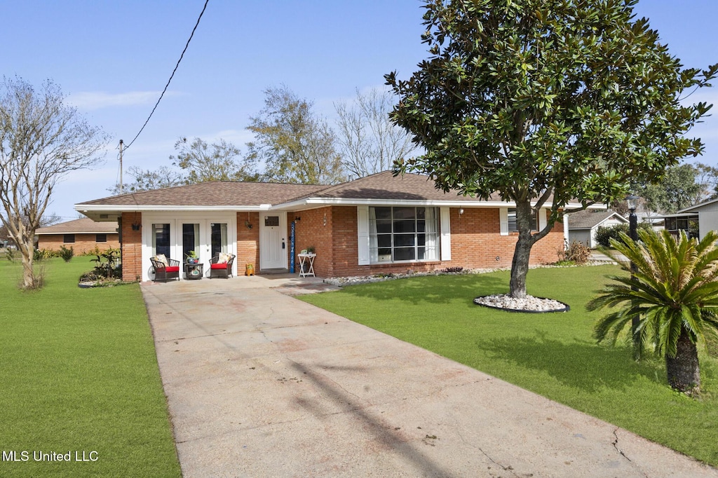 view of front of home with a front lawn and french doors