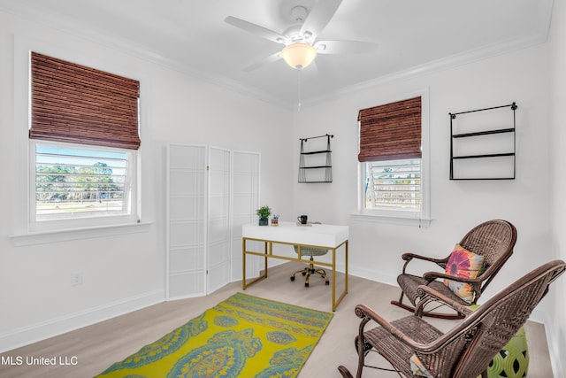 office space featuring light wood finished floors, ceiling fan, baseboards, and crown molding