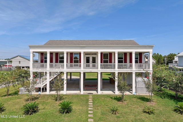 back of property featuring a porch, a yard, stairway, and a shingled roof