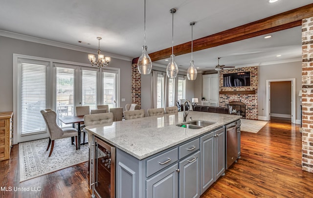 kitchen with gray cabinetry, a sink, beverage cooler, open floor plan, and dark wood-type flooring
