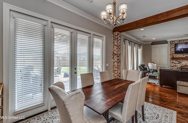 dining area featuring crown molding, a notable chandelier, a fireplace, recessed lighting, and wood finished floors
