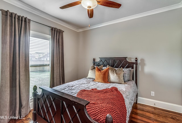 bedroom featuring ceiling fan, baseboards, ornamental molding, and wood finished floors
