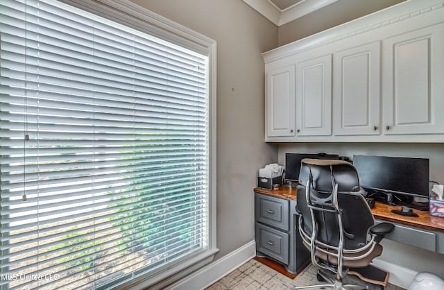 office area featuring baseboards and built in desk