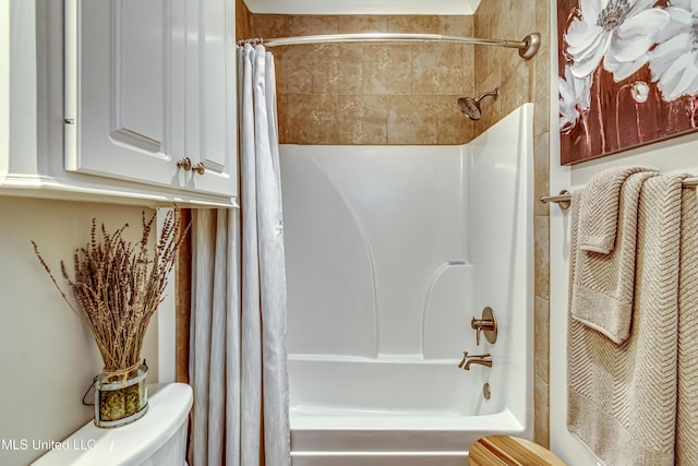 bathroom featuring toilet and shower / bath combination with curtain