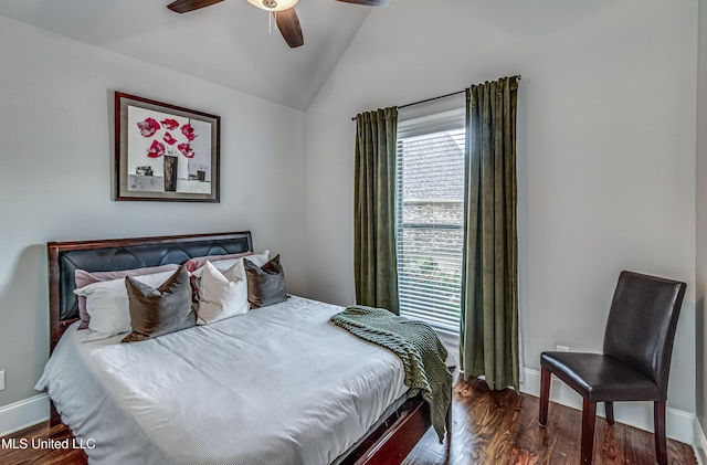 bedroom featuring baseboards, ceiling fan, wood finished floors, and vaulted ceiling