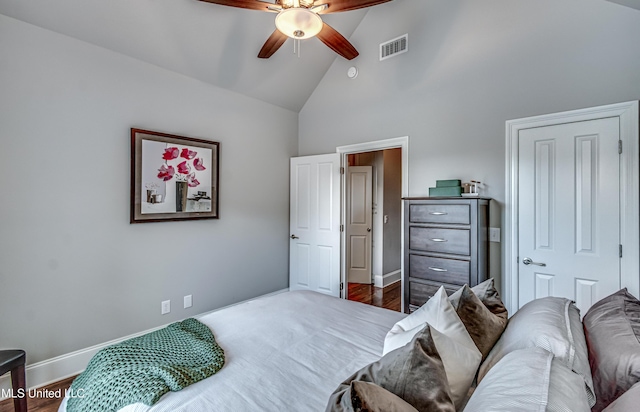 bedroom featuring high vaulted ceiling, a ceiling fan, baseboards, wood finished floors, and visible vents