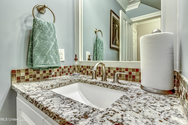 bathroom with vanity and tasteful backsplash