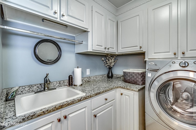 laundry room featuring washer / clothes dryer, a sink, and cabinet space