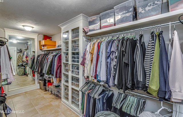 walk in closet with tile patterned floors