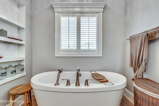 bathroom with plenty of natural light and a soaking tub